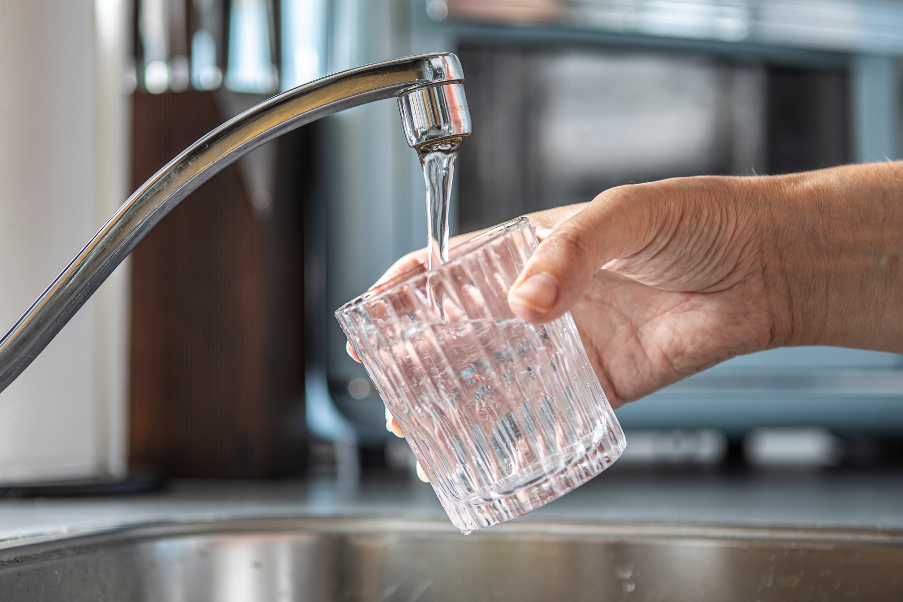 drinking glass being filled with tap water drinking glass being filled with tap water