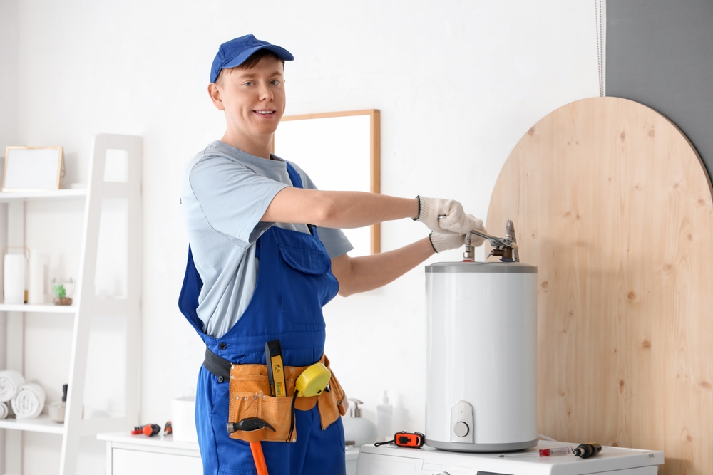 A professional plumber inspecting and servicing a residential water heater tank to ensure energy efficiency and reliable hot water. A professional plumber inspecting and servicing a residential water heater tank to ensure energy efficiency and reliable hot water.